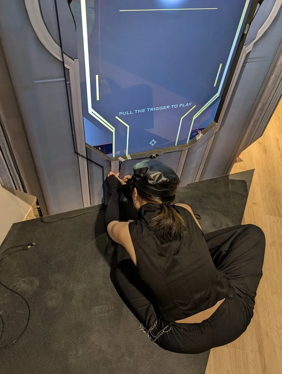 A crew member crouches under the screen to fit the sensor at its bottom edge
