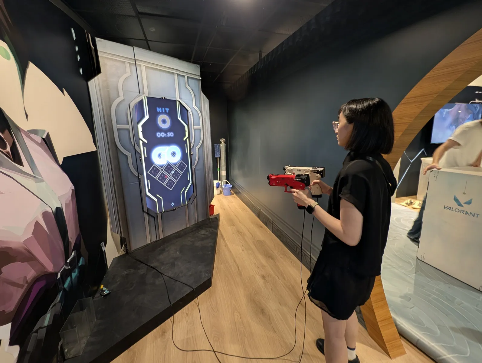 A crew member tests the game with the red light gun on installation day